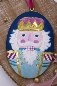 Nutcracker w/ Gold Accents 6x9" Oval Metal Disc Ornament